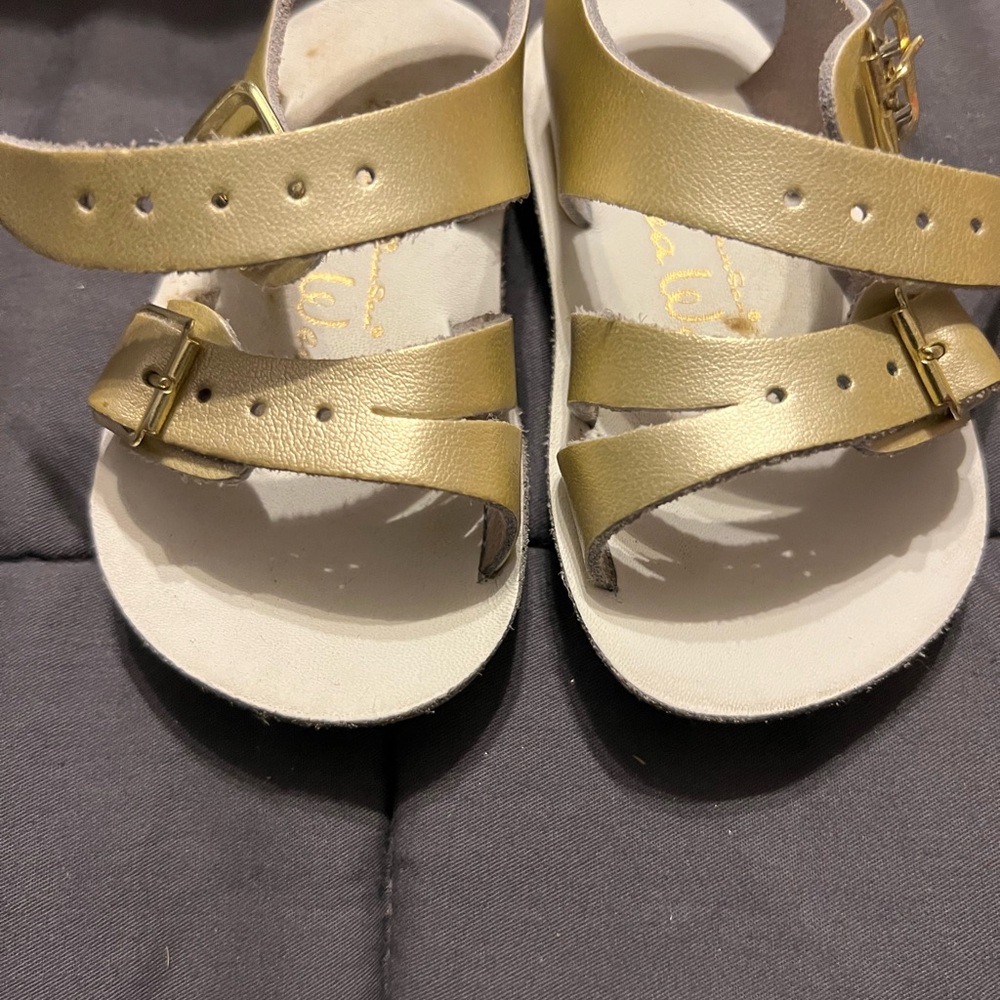 Gold and silver pairs of sun-San Sandals